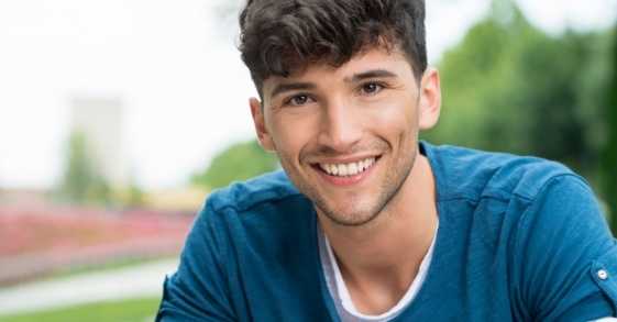 Smiling teenage boy in blue tee shirt