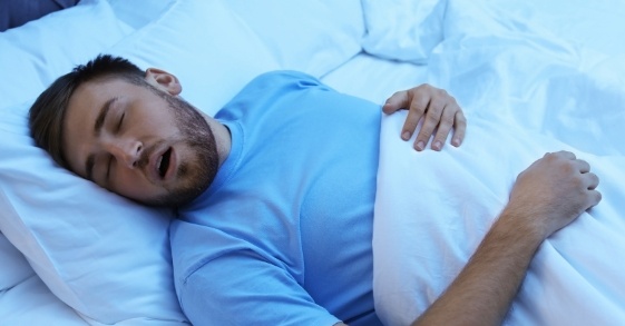 Man sleeping on his back with his mouth open