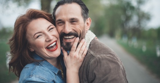 Man and woman laughing together outdoors
