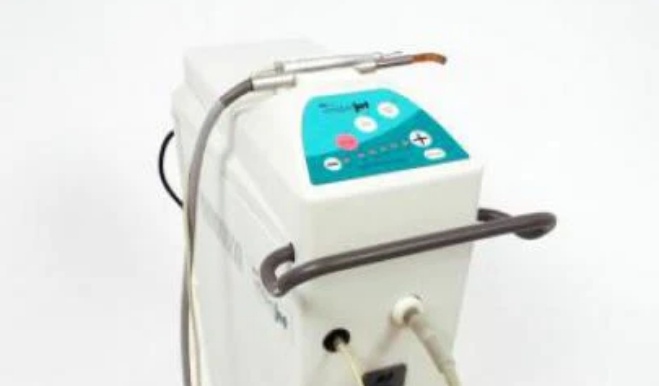 White box with buttons and cords connected to dental instruments