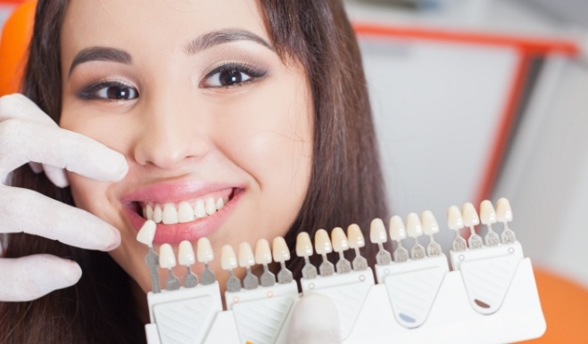 Woman smiling while getting veneers from San Marcos cosmetic dentist